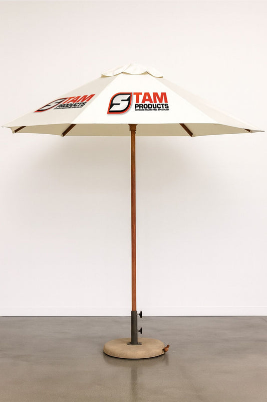 Stam Products custom outdoor branded hexagonal umbrella with wooden frame and beige canopy displaying company logo