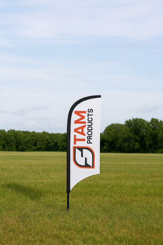 Stam Products bespoke printed branded arc flag banner with black edging displayed outdoors on grassy field