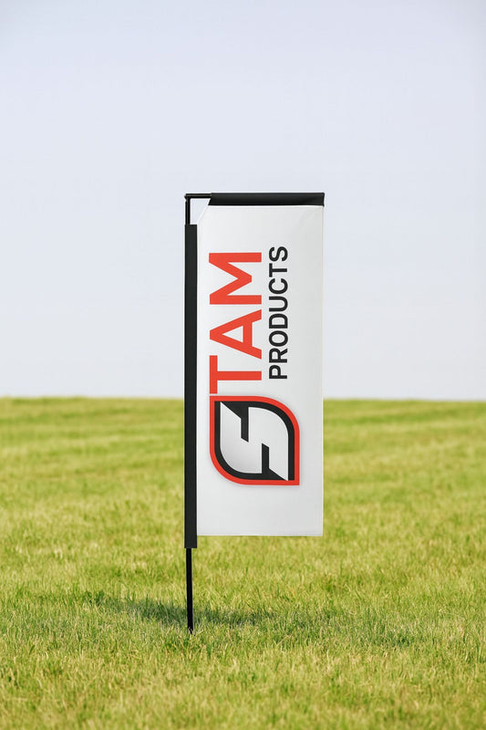 Stam Products bespoke branded telescopic flag banner with logo on aluminum frame set in grassy outdoor area