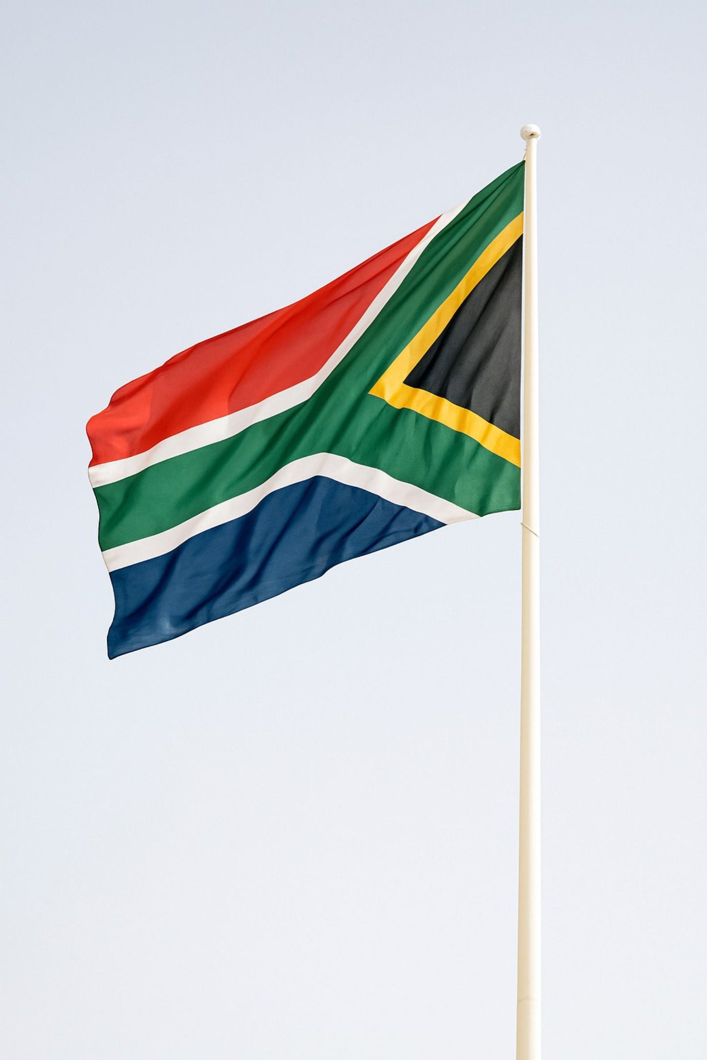 High quality custom printed South African country flag on a pole waving outdoors