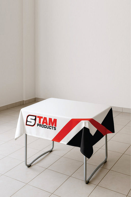 White custom printed branded table cloth by Stam Products on a small metal table in a tiled room