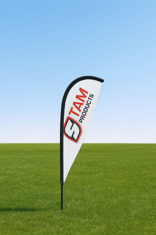 Custom printed Stam Products branded white fin flag banner on green grass with blue sky background