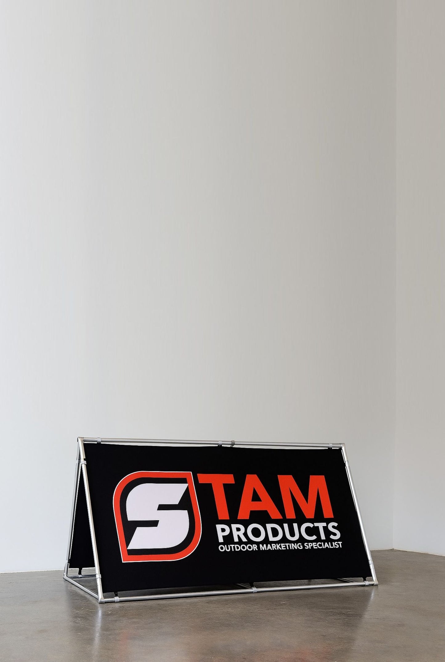 Stam Products custom printed A-frame banner with black background and orange and white logo on aluminum frame