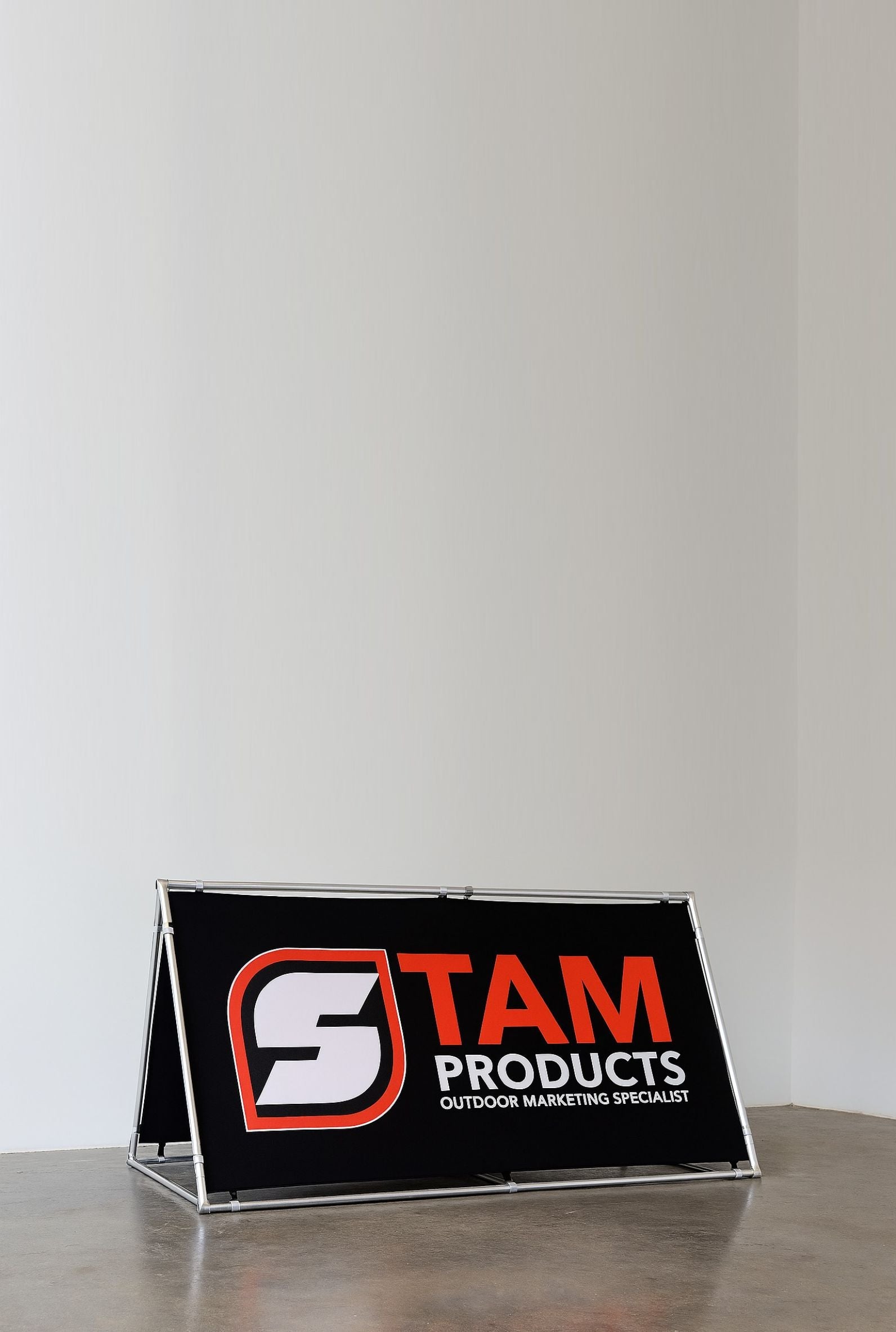 Stam Products custom printed A-frame banner with black background and orange and white logo on aluminum frame