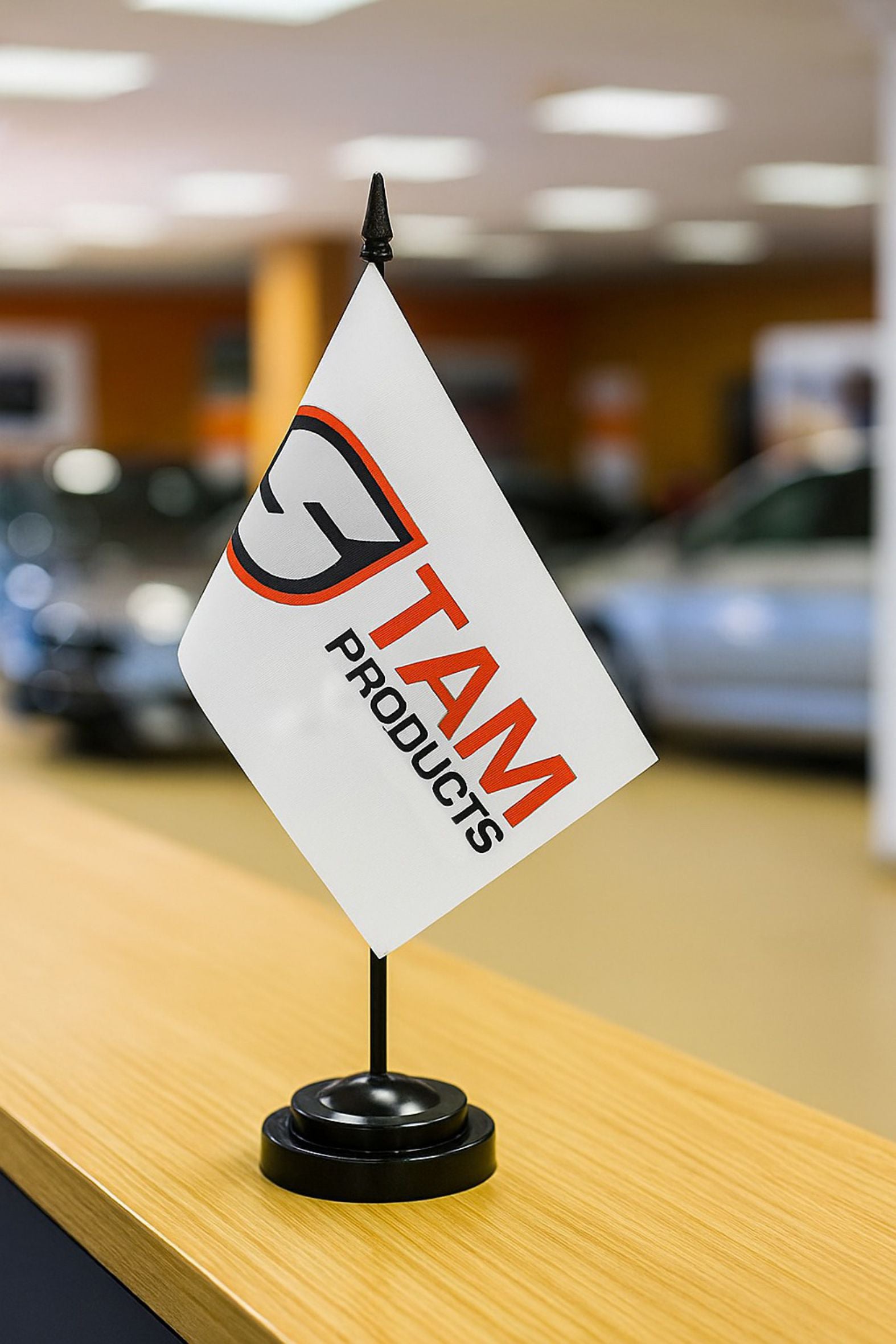 Stam Products custom branded corporate desk flag with logo on white polyester fabric and black base stand